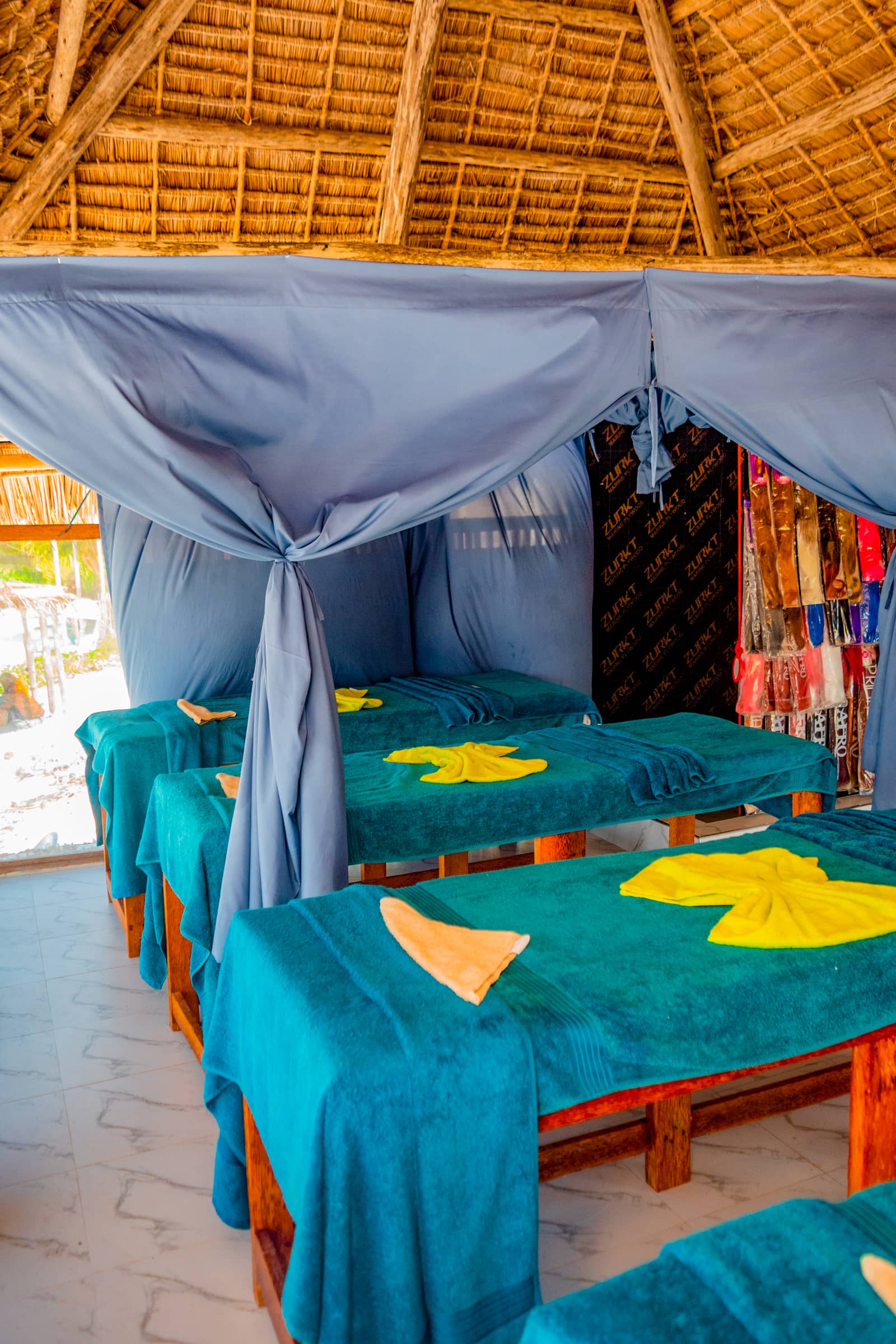 Massage treatment room with wooden beds at MSANGI SPA & BEAUTY